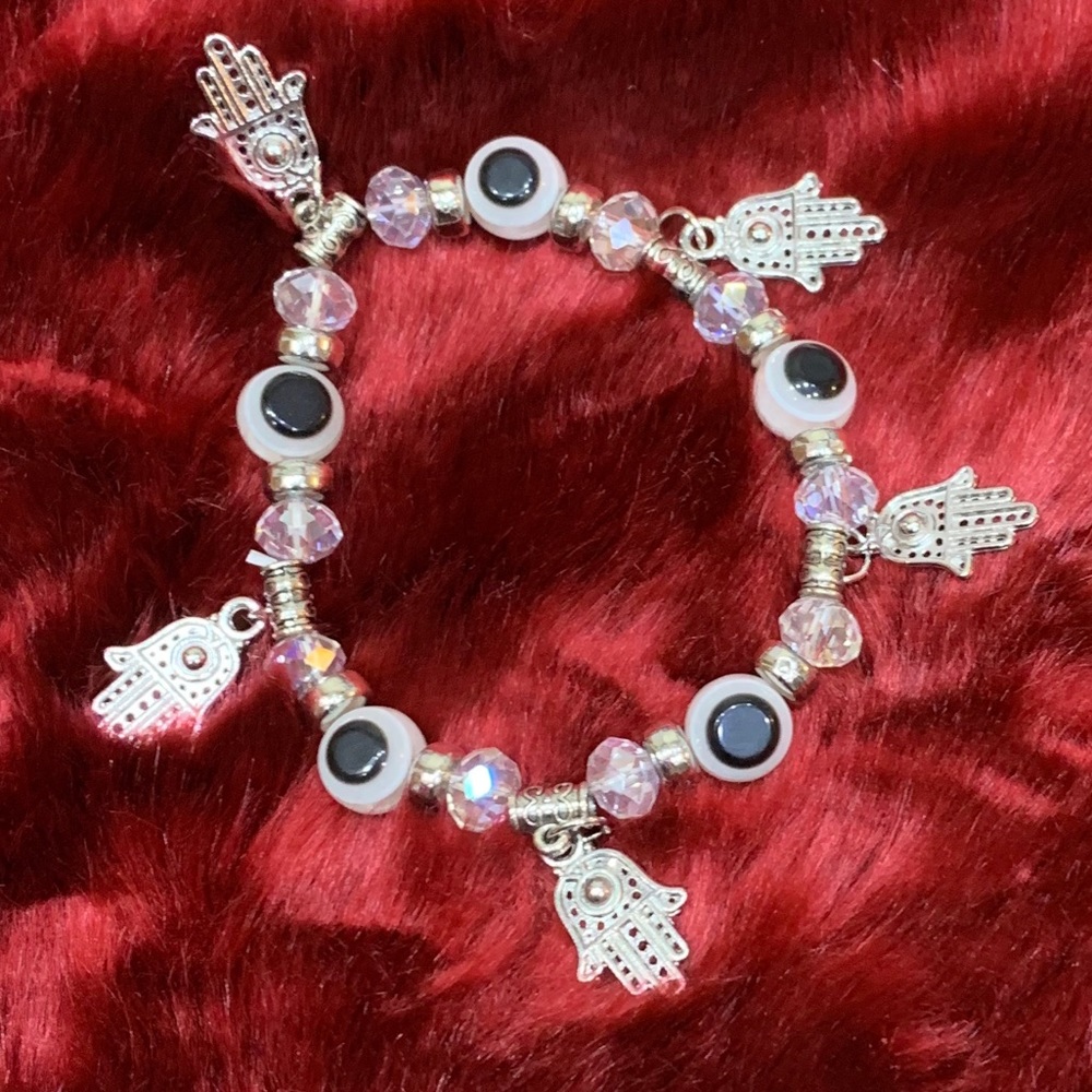 Eye bracelet in white and clear with hands hands.